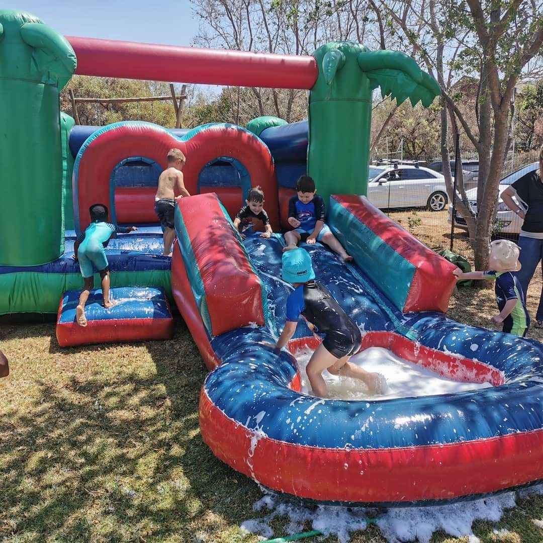 A bouncing castle water slide for a kid's birthday party.