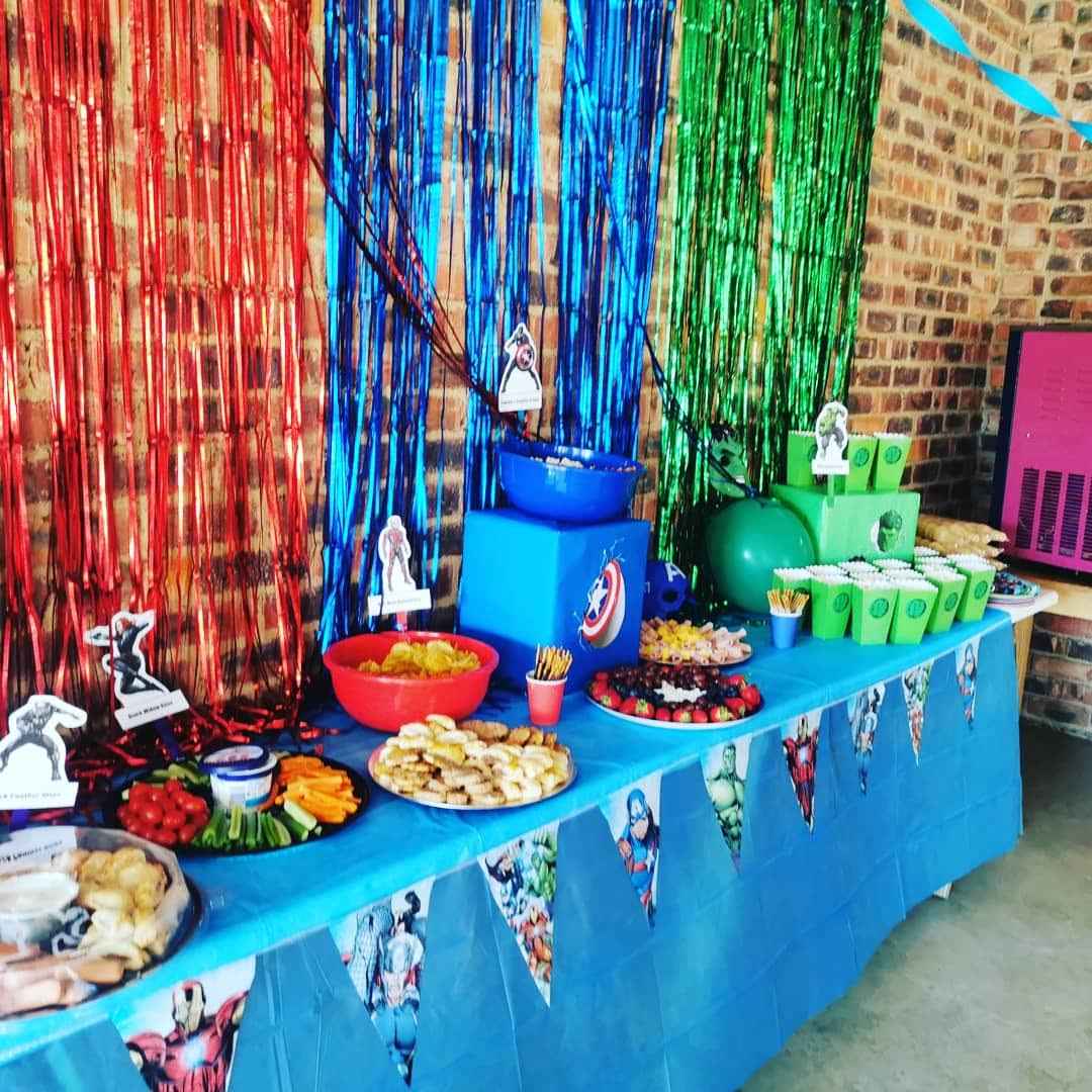 A colorful table set up for a kid's party at The Barn on Boundary Party Venue Johannesburg with various snacks