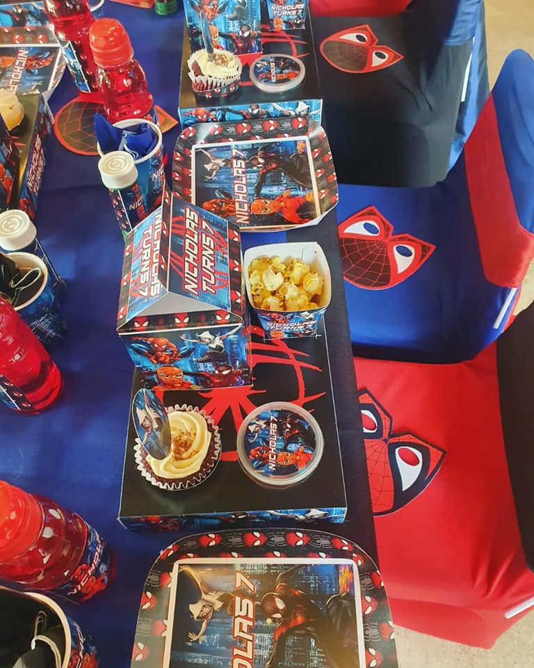 Spider-Man themed party table setup with decorated cupcakes, popcorn, and drinks at the Barn on Boundary Party Venue in Johannesburg, Northriding.